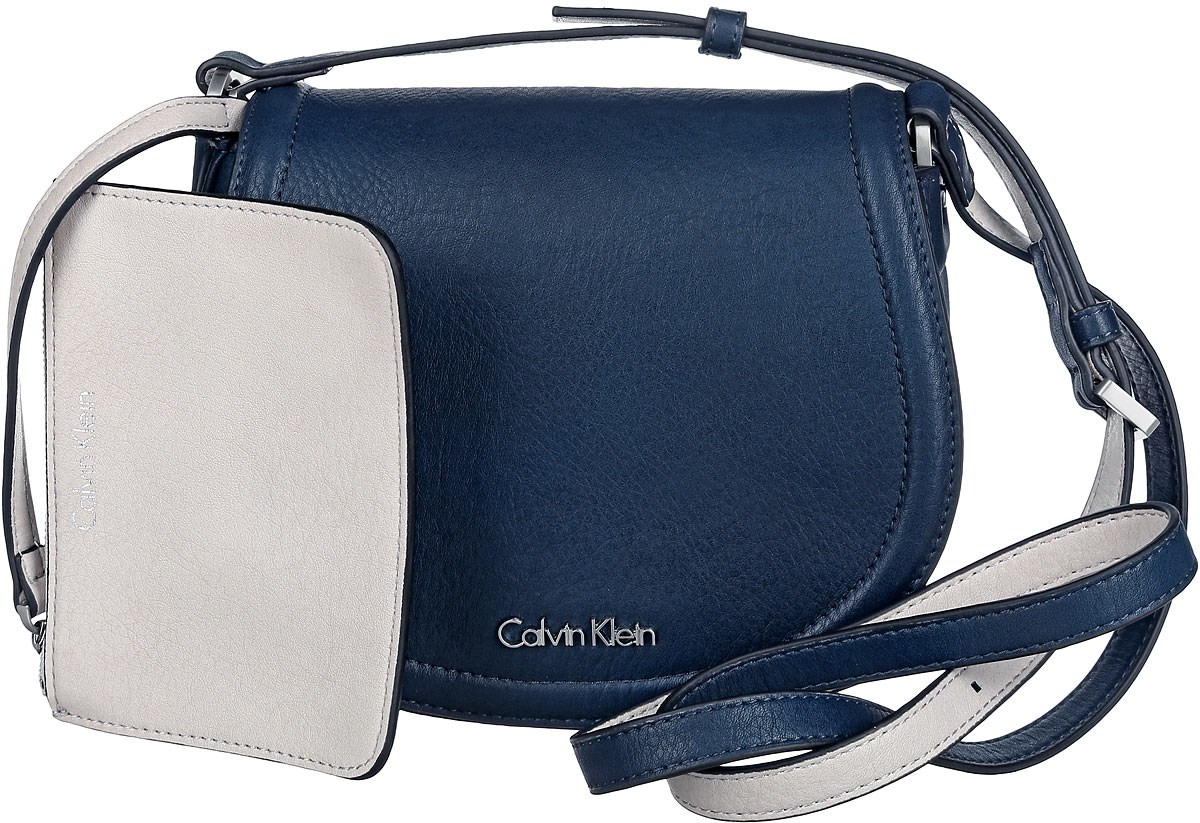 Сумка женская Calvin Klein Jeans, цвет: темно-синий. K60K601646_9020K60K601646_9020 Сумка женская Calvin Klein Jeans, цвет: темно-синий. K60K601646_9020K60K601646_9020Стильная сумка Calvin Klein выполнена из искусственной кожи с зернистой фактурой, оформлена металлической фурнитурой с логотипом бренда. Изделие содержит одно отделение, которое закрывается клапаном на магнитную кнопку. Внутри сумки размещены накладной кармашек для мелочей и врезной карман на застежке-молнии. Сумка оснащена практичным плечевым ремнем регулируемой длины. В комплекте с изделием поставляется небольшой кошелек на застежке-молнии, который фиксируется к сумке при помощи карабина, и чехол для хранения. Модная сумка идеально подчеркнет ваш неповторимый стиль.