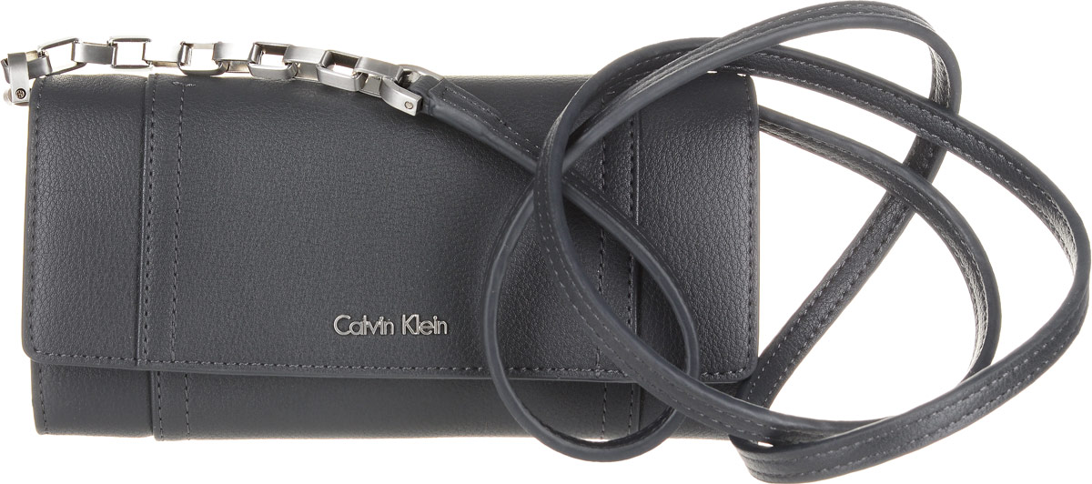 Кошелек женский Calvin Klein Jeans, цвет: черный. K60K602432_0040K60K602432_0040 Кошелек женский Calvin Klein Jeans, цвет: черный. K60K602432_0040K60K602432_0040Элегантный кошелек Calvin Klein Jeans выполнен из искусственной кожи (полиуретана) и оформлен металлической пластиной с названием бренда. Изделие закрывается клапаном на кнопку. Внутри кошелька расположены четыре отделения для купюр, отделение для монет на молнии, потайной кармашек и двенадцать карманов для пластиковых карт. На задней стороне изделия имеется прорезной карман на застежке-молнии. Дополнена модель плечевым ремнем.