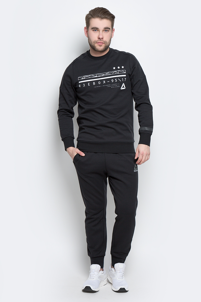 СвитшотBK4713 СвитшотBK4713Мужской свитшот Reebok Wor C Graphic Crew, выполненный из хлопка с добавлением полиэстера, идеально подойдет для повседневной носки и занятий спортом. Свитшот с круглым вырезом горловины и длинными рукавами оформлен оригинальным принтом с надписями. На рукавах предусмотрены широкие манжеты. Низ изделия дополнен трикотажной резинкой.
