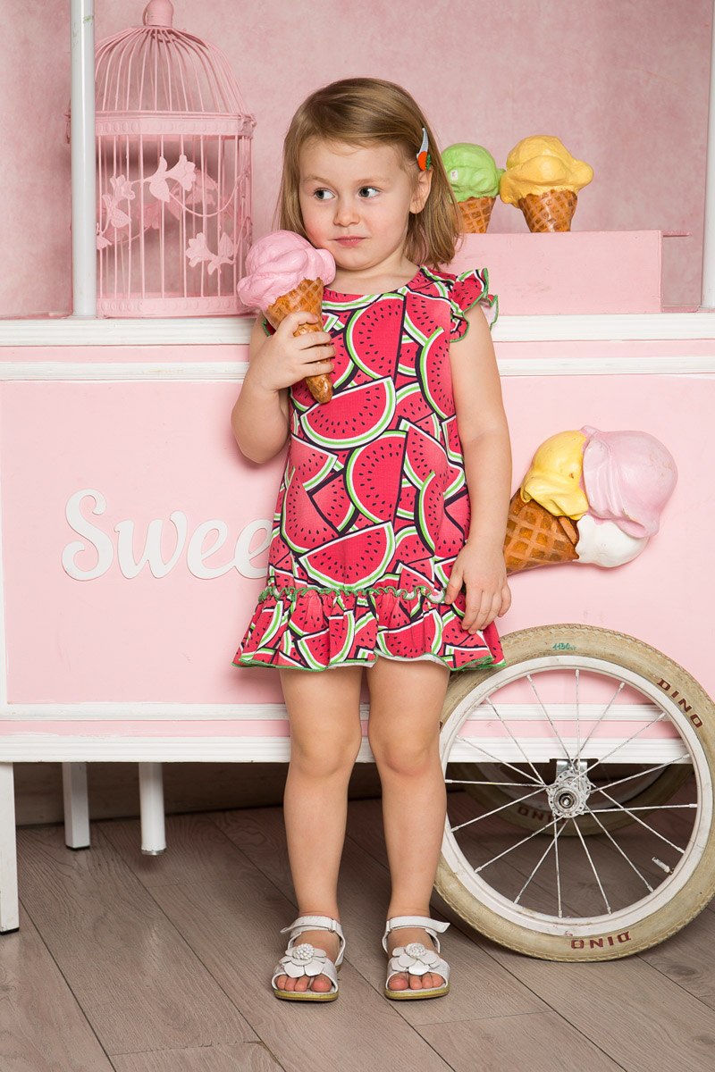 Платье712090 Платье712090Яркое платье для девочки Sweet Berry выполнено из качественного эластичного хлопка. Модель свободного кроя с юбкой-воланом и рукавами-крылышками оформлена принтом с изображением арбузов и контрастной строчкой.