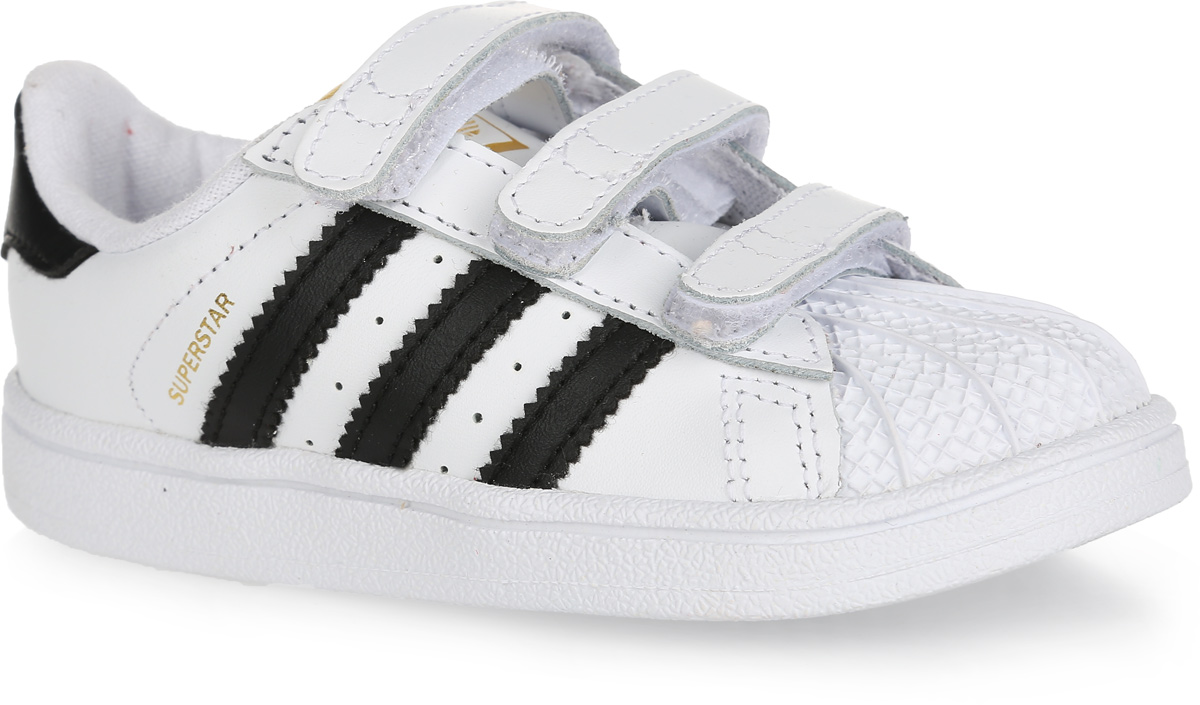 КроссовкиS77611 КроссовкиS77611Модные кроссовки Superstar Foundation CF I от adidas Originals - это культовая модель adidas Superstar для самых маленьких ножек. Верх, выполненный из натуральной и искусственной кожи, оформлен на заднике и на язычке логотипом бренда, сбоку - названием модели. Классический прорезиненный мысок-ракушка защитит ногу от ударов. Ремешки с застежками-липучками надежно фиксируют модель на ноге. Подкладка из текстиля не натирает. Антимикробная стелька OrthoLite из материала EVA с текстильной поверхностью отводит влагу и обеспечивает комфорт при движении. Резиновая подошва с узором-елочкой гарантирует идеальное сцепление с любыми поверхностями. В таких кроссовках ногам вашего ребенка будет комфортно и уютно.